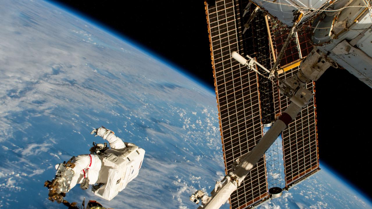 An astronaut attached to the Canadarm2 robotic arm's latching end effector — the same configuration Anil Menon will ride on Tuesday. (NASA, Jan. 30, 2025)