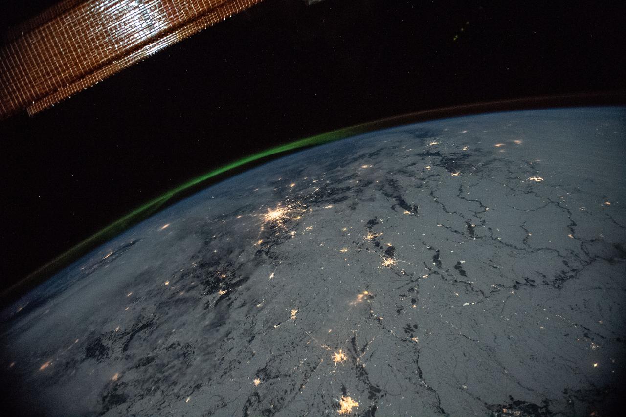 View of the Earth's limb with an aurora, photographed from the International Space Station — a quiet Sunday register, no work in progress, the station looking down rather than out. (NASA)