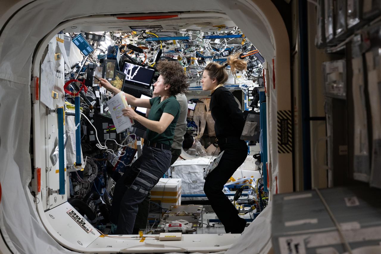 Expedition 75 commander Jessica Meir (left) and ESA flight engineer Sophie Adenot study Canadarm2 robotic-arm procedures on August 17, 2026, to support spacewalk operations to replace a space-to-ground antenna outside the International Space Station — the procedure work that Tuesday's walk will finally complete. (NASA / Anil Menon)