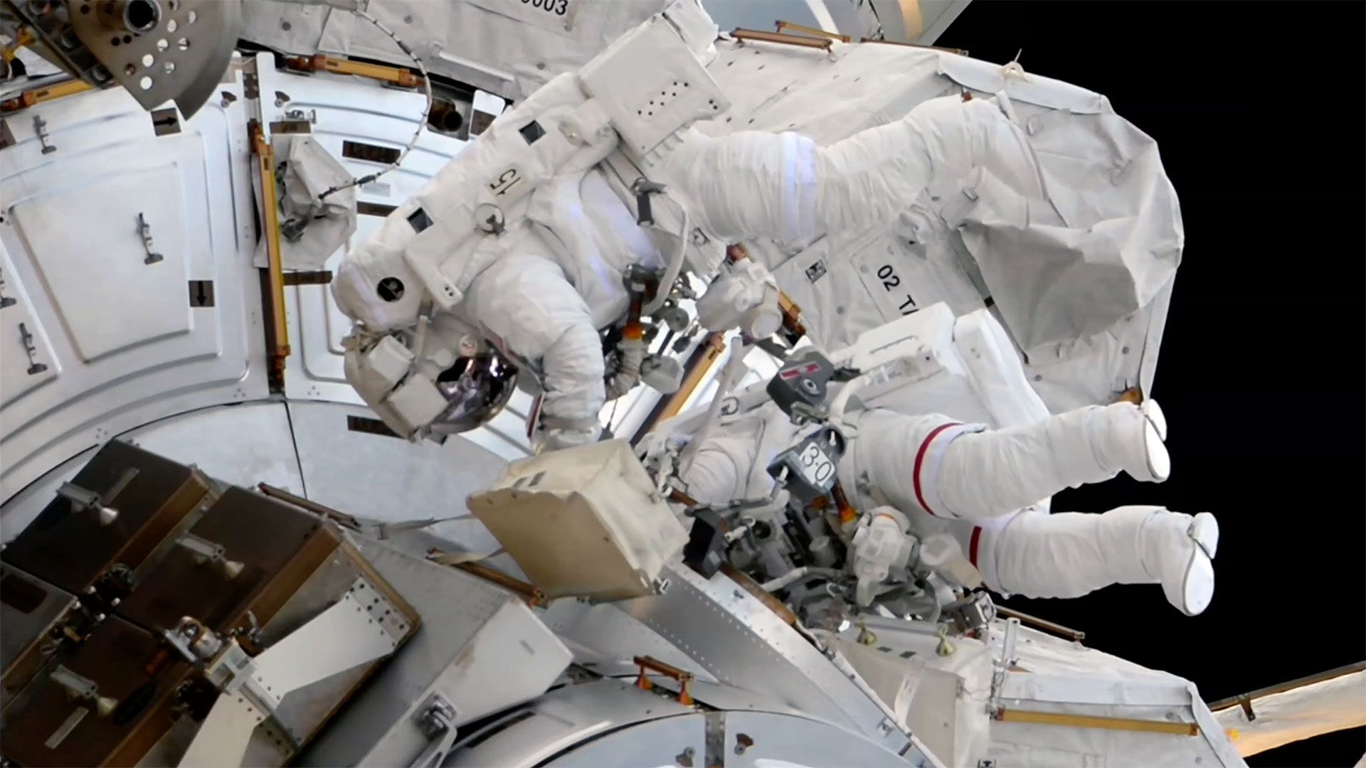 NASA astronaut Jessica Meir and ESA astronaut Sophie Adenot outside the Quest airlock during U.S. Spacewalk 99 on September 1, 2026 — Adenot in the spacesuit with red stripes as EV1, Meir unmarked as EV2. (NASA, via Space.com)