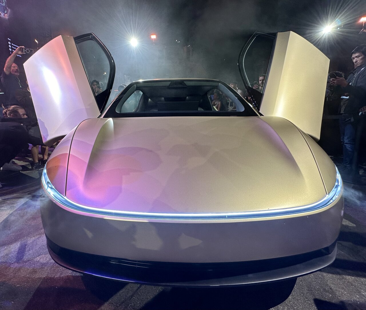 Tesla Cybercab, front view, photographed at the October 2024 unveiling at Warner Brothers. Twenty vehicles drove guests around fully autonomously that evening. By September 2026, the car was on Austin streets under an open NHTSA audit of its FMVSS certification.